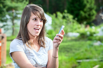 Angry woman screaming in cell phone, outdoors. Copyspace