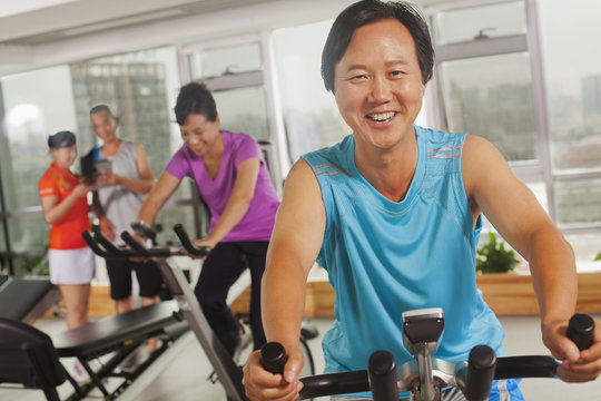 Man smiling and exercising on the exercise bike