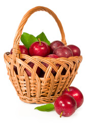ripe plums in a wicker basket