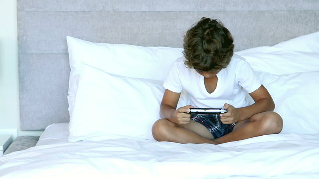 Child playing a video game in his bedroom