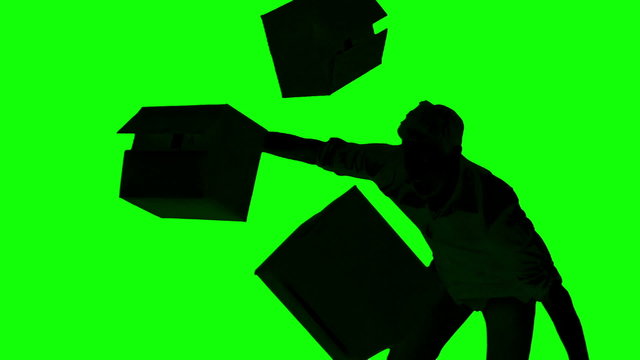 Silhouette of clumsy man dropping boxes on green screen