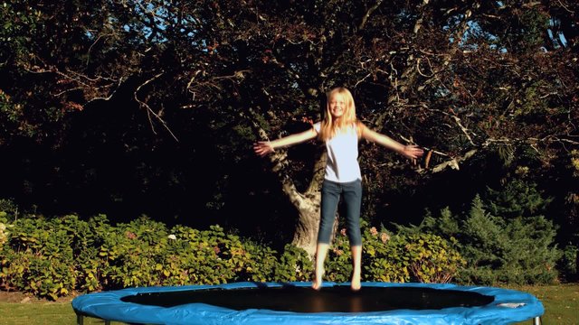 Little girl having fun on a trampoline