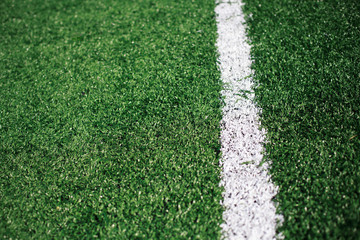 White stripe on the green soccer field from top view