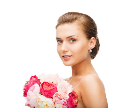 Woman Wearing Earrings And Holding Flowers