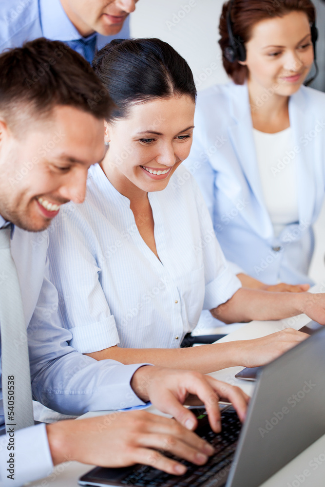 Wall mural group of people working with laptops in office