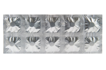 Closed up medicine tablet in aluminum foil strip background