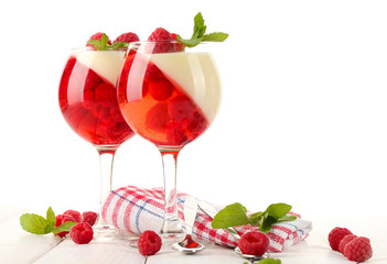 fruit jelly with raspberries in glasses on wooden table