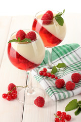 fruit jelly with berries in glasses on wooden table