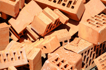 Group of red bricks thrown at the construction site