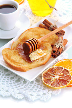 White bread toast with honey and cup of coffee, isolated