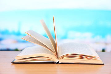 Opened book on bright background