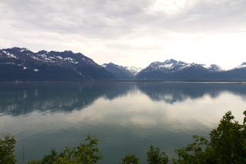 reflections of mountains in valdez bay