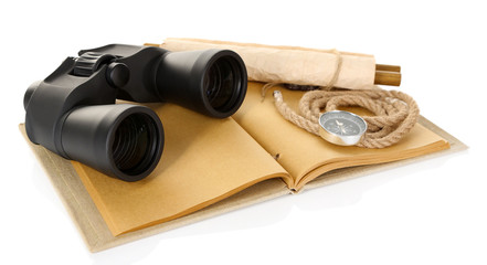 Black modern binoculars with old notebook isolated on white