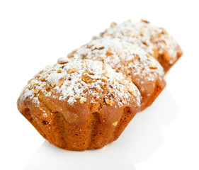 Tasty muffin cakes with powdered sugar, isolated on white