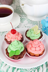 Delicious beautiful  cupcakes on dining table close-up