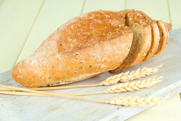 Hot tasty bread, on cutting board, close up