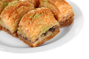 Sweet baklava on plate isolated on white