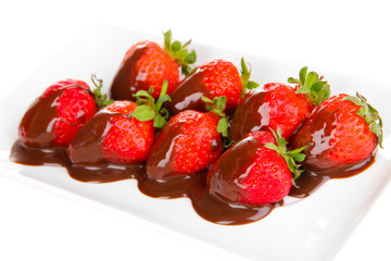 Strawberry dipped in chocolate fondue isolated on white