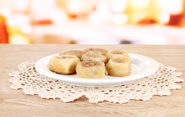 Sweet baklava on plate on table in room