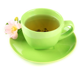 Cup of herbal tea with hip rose flower, isolated on white