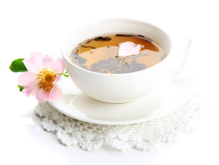 Cup of herbal tea with hip rose flowers, isolated on white