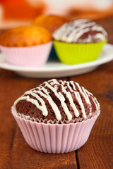 Sweet cupcakes on wooden table