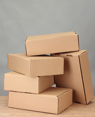 Parcels boxes on wooden table, on grey background