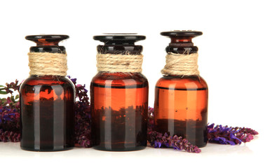 Medicine bottles and salvia flowers, isolated on white