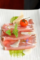 Carpaccio of tuna with tomatoes, parmesan cheese and spices