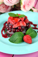 Tasty jelly dessert with fresh berries, on pink roses