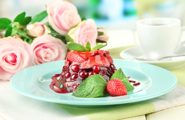 Tasty jelly dessert with fresh berries, on bright background