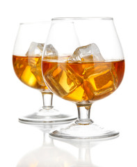 Brandy glasses with ice isolated on white
