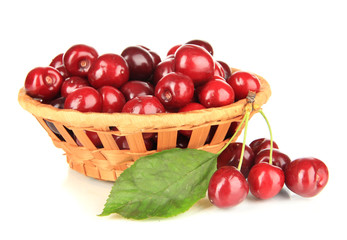 Cherry berries in wicker basket isolated on white
