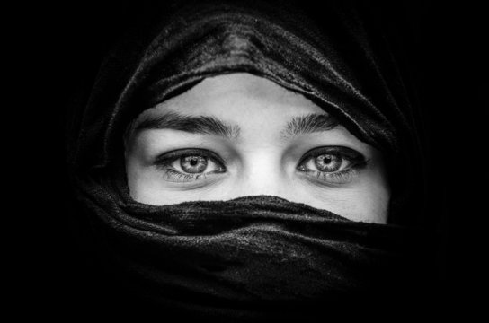 Portrait of beautiful woman with blue eyes wearing black scarf i