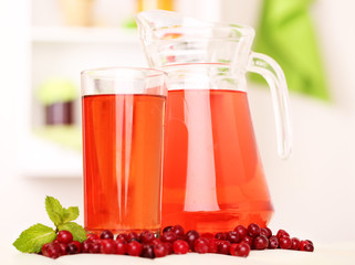 Pitcher and glass of cranberry juice with red cranberries