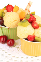 Delicious  ice cream with fruits and berries in bowl close up