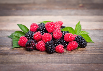 Mixed berry fruits on the wooden background