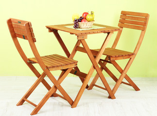 Wooden table with fruit in room