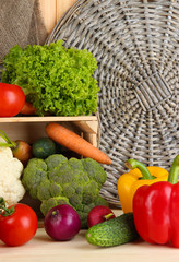 Fresh vegetables in wooden box on table close up