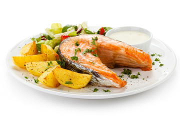 Grilled salmon, baked potatoes and vegetables