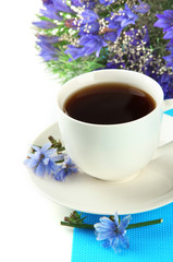 Cup of tea with chicory, isolated on white