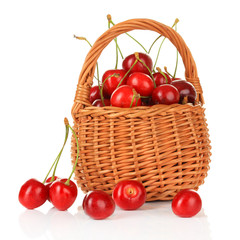 Cherry berries in wicker basket isolated on white