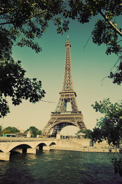 Eiffel Tower and bridge on Seine river in Paris, France. Vintage