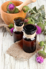 Medicine bottles and mortar with thistle flowers