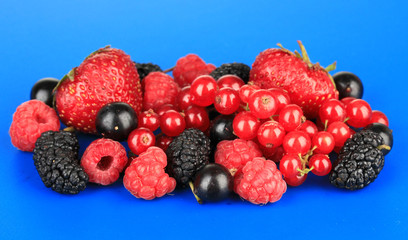 Ripe berries on blue background