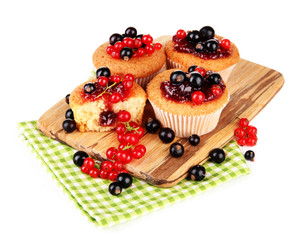 Tasty muffins with berries isolated on white