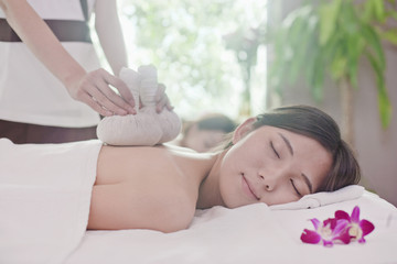 Obraz na płótnie Canvas Women Receiving Herbal Massage