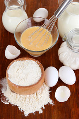 Fototapeta na wymiar Ingredients for dough on wooden table close-up