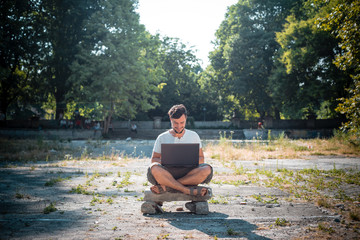 young stylish man using notebook