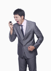 Naklejka premium Businessman yelling at mobile phone